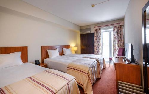 Foto de una habitación de Catolica Hotel