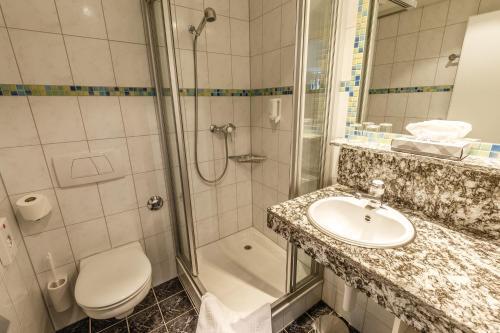 Foto del baño de Hotel Arenas Resort Victoria-Lauberhorn