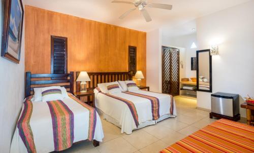 Foto de una habitación de Villas El Encanto Cozumel
